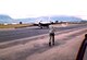 A USAF U-2 equipped for High Altitude Sampling Program (HASP) missions. The aircraft lands and characteristically falls to one side on its wing skids as it slows. A ground crewman runs to collect the braking parachute. Others inserted “pogo” wheels in the wings to right the aircraft and allow it to maneuver on the ground. The U-2 in this picture is on Fiji Island en route to Australia in 1961. (U.S. Air Force photo)