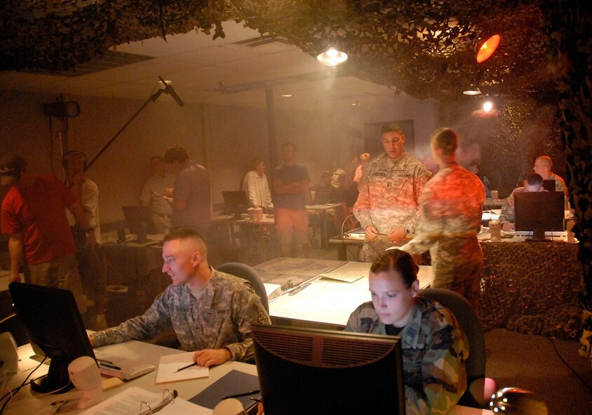 A training area inside the National Air and Space Intelligence Center at Wright-Patterson Air Force Base, Ohio is transformed into a motion picture production set on June 27.  U.S. Army Reserve Sgt. Jeremiah Minor, an intelligence analyst at the Joint Reserve Intelligence Center, will be featured in an upcoming Army recruiting commercial filmed here.  (Master Sgt. Dale Grabow/U.S. Air Force)