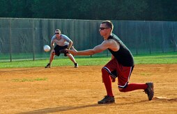 Morgan Jarrett, 437th Civil Engineer Squadron team 1, pitches the ball into play, as James Baillie,437 CES 1, waits anxiously to see where the ball will be hit July 10. (U.S. Air Force Photo/Airman 1st Class Katie Gieratz)