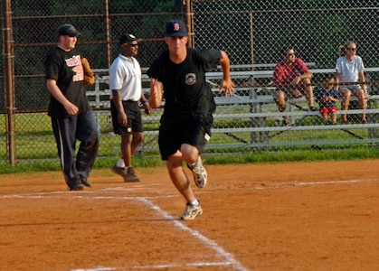 Christopher Freehart, 437th Aerial Port Squadron, runs as fast as he can towards first base... Safe! (U.S. Air Force Photo/Airman 1st Class Katie Gieratz)