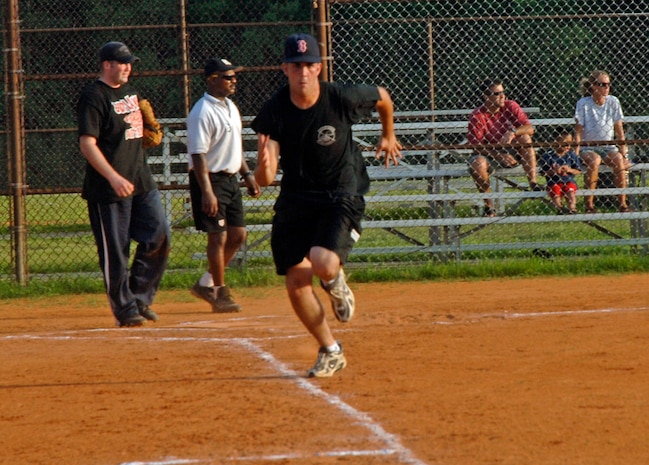 Christopher Freehart, 437th Aerial Port Squadron, runs as fast as he can towards first base... Safe! (U.S. Air Force Photo/Airman 1st Class Katie Gieratz)