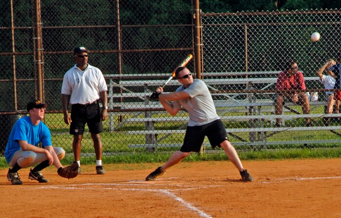 James Baillie,437th Civil Engineer Squadron, keeps his eye on the ball as it flies towards him, before swinging away July 10.  (U.S. Air Force Photo/Airman 1st Class Katie Gieratz)