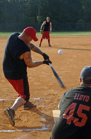 Eddie Amburgey, 437th Aerial Port Squadron, slams the ball to out field and takes first base July 10.(U.S. Air Force Photo/Airman 1st Class Katie Gieratz)