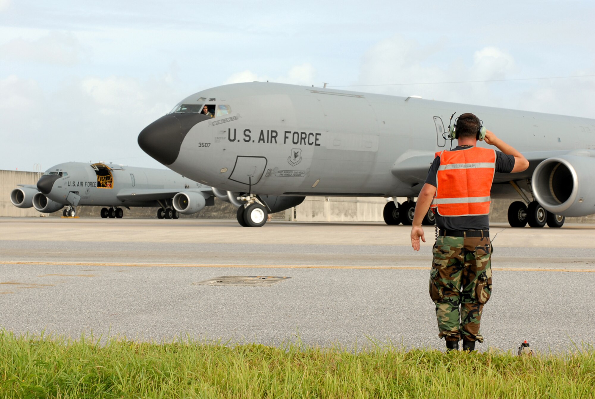 Senior Airman Shawn Denoma salutes as a KC-135 Stratotanker taxis for departure at Kadena Air Base, Japan, July 12, 2007, enroute to Anderson Air Force Base, Guam as part of the base's typhoon evacuation.  In preparation for Typhoon Man-Yi, the majority of KC-135 aircraft assigned to the base are being evacuated. Typhoon Man-Yi, the first typhoon of the year for Okinawa, is expected to make landfall Friday at Kadena. Airman Denoma is assigned to 718th Aircraft Maintenance Squadron. U.S. Air Force  photo/Airman 1st Class Kelly Timney