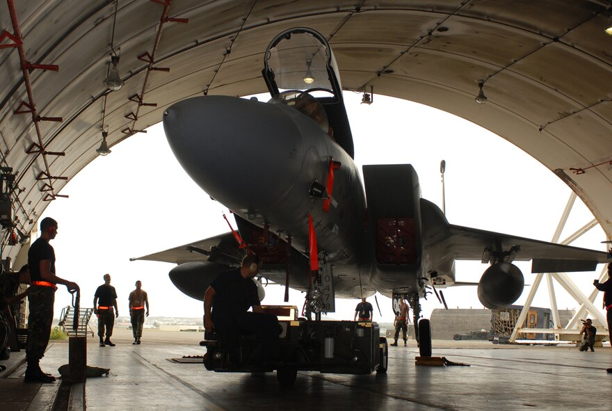 Airmen from the 18th Aircraft Maintenance Squadron tow an F-15C Eagle into a protective aircraft shelter on Kadena Air Base, Japan, July 12, 2007.  Some base aircraft  were moved into hangars and protective aircraft shelters to keep them safe from fast approaching Typhoon Man-Yi, the first for Okinawa this year.  It's expected to make landfall Friday at Kadena. Sergeant Farr is a crew chief with the 18 Aircraft Maintenance Squadron.  U.S. Air Force  photo/Airman 1st Class Kelly Timney