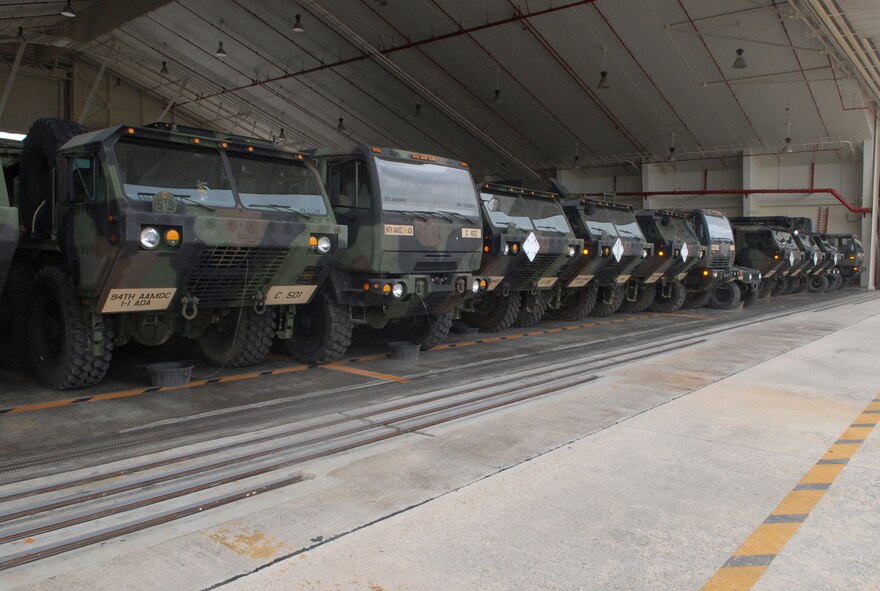 KADENA AIR BASE, Japan -- Trucks loaded with Patriot missile equipment from the 1-1 Air Defense Artillery Battalion sit inside a hangar as part of typhoon preparation here July 12. Typhoon Man-Yi, the first typhoon of the year for Okinawa, is expected to make landfall here Friday. (U.S. Air Force photo by Staff Sgt. Steven Nabor)