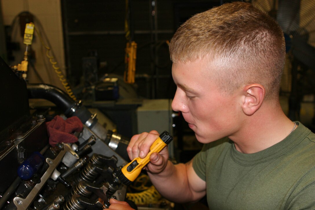 Lance Cpl. Spencer C. Mitchell replaces fuel injectors on an amphibious assault vehicle engine .  The engines, once repaired, will return to their respective units for future use.  Mitchell is a vehicle mechanic with General Support Maintenance Company, 2nd Maintenance Battalion, 2nd Marine Logistics Group.
