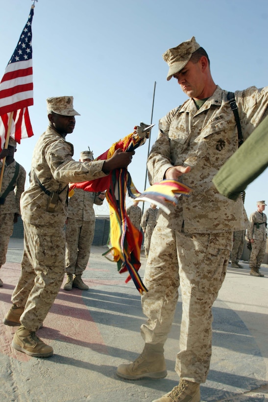AL TAQADDUM, Iraq (July 13, 2007) ? Sgt. Maj. J.B. Edwards and Lt. Col. Phillip W. Boggs unfurl the battalion?s organizational colors in a transfer of authority ceremony here July 13.  1st Battalion, 11th Marine Regiment took control over the area of operations from 2nd Combined Arms Battalion, 136th Infantry Regiment.  Edwards is the sergeant major 1st Battalion, 11th Marine Regiment and Boggs is the commanding officer.