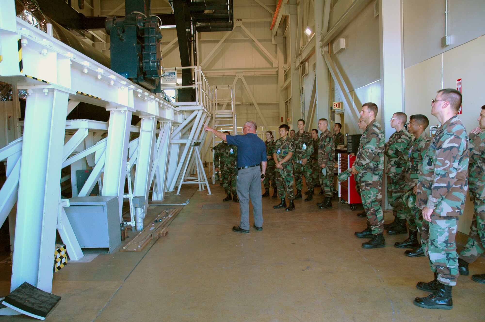 VANDENBERG AIR FORCE BASE, Calif. -- Airmen who will escort representatives of the Stategic Arms Reduction Treaty listen on June 11 as Butch Price explains what the Russian investigators will be looking for during their inspection.  The inactive launch vehicle is a training tool for missile maintainers who assist during START inspections.  (U.S. Air Force photo/Senior Airman Stephen Cadette)