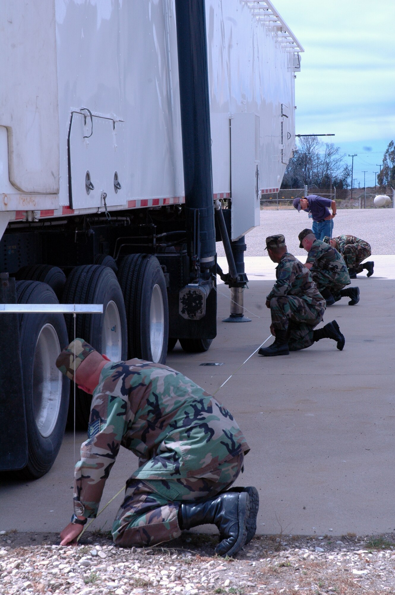 VANDENBERG AIR FORCE BASE, Calif. -- Airmen from the 1st Air and Space Test Squadron measure the length of a Minuteman III transporter/erector vehicle June 11.  Their work supported the Strategic Arms Reduction Treaty exercise by walking Airmen through steps the inspectors will take when they come to Vandenberg.  (U.S. Air Force photo/Senior Airman Stephen Cadette)