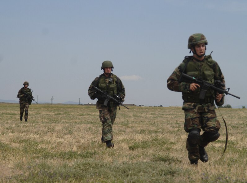 FAIRCHILD AIR FORCE BASE, Wash. –Senior Airman David Jones, Staff Sgt. Levi Wilson and Senior Airman Lonnie Bell march to the next checkpoint in a practice training course here, July 13. The three-Airman team is training for the Air Mobility Command Rodeo 2007 which will be held at McChord AFB, Wash. at the end of July. (U.S. Air Force photo / Senior Airman Chad Watkins)