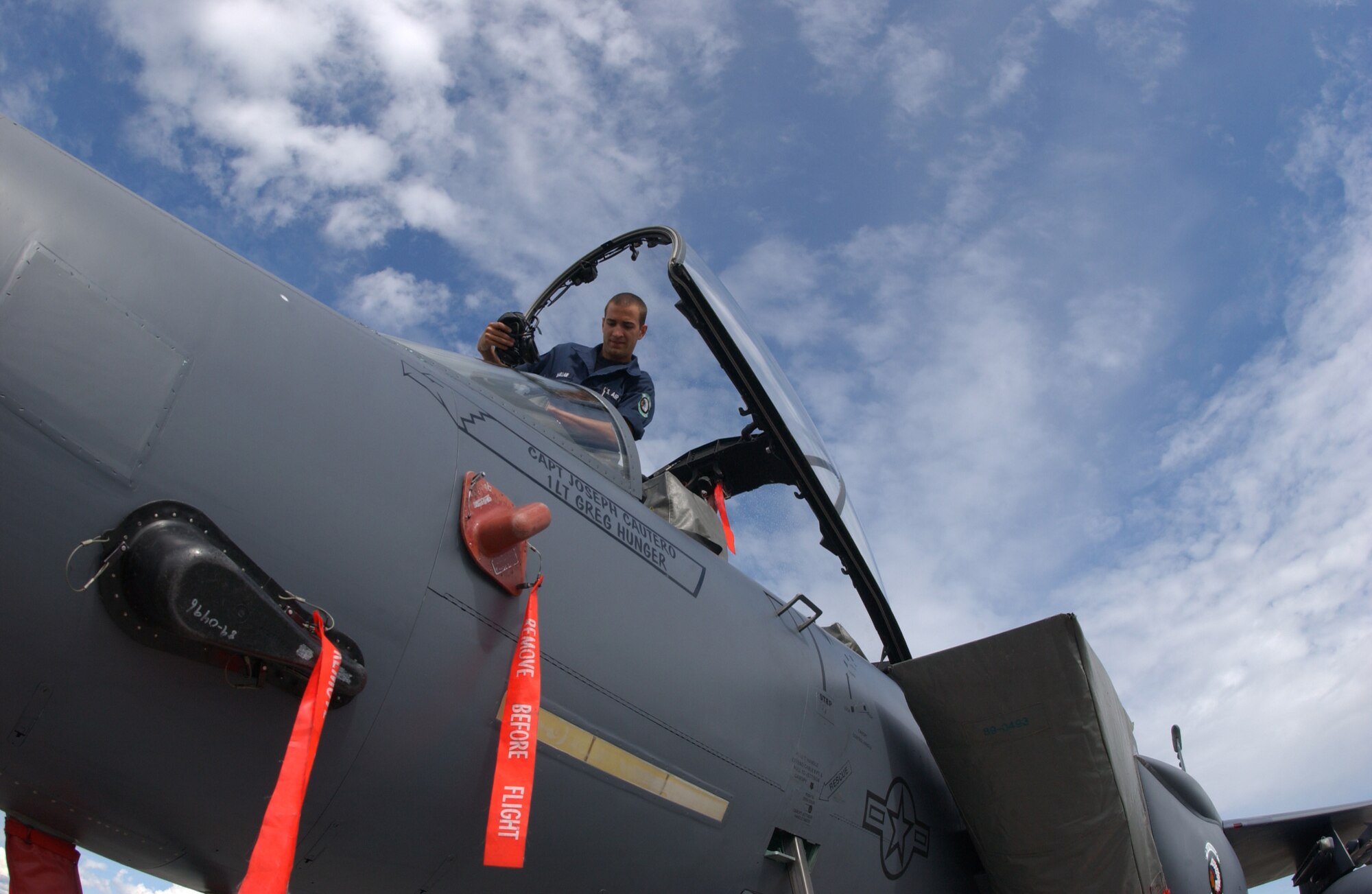 EIELSON AIR FORCE BASE, Alaska -- Airman 1st Class Harrison McMillan, 335th Aircraft Maintenance Unit, Seymour Johnson Air Force Base, N.C., climbs into the cockpit to troubleshoot the landing gear of an F-15E Strike Eagle July 12. Red Flag-Alaska 07-3 is a Pacific Air Forces-directed field training exercise for U.S. and coalition forces flown under simulated air-combat conditions. It is conducted on the Pacific Alaska Range Complex with air operations flown out of Eielson and Elmendorf Air Force Bases. (U.S. Air Force Photo by Airman 1st Class Jonathan Snyder)