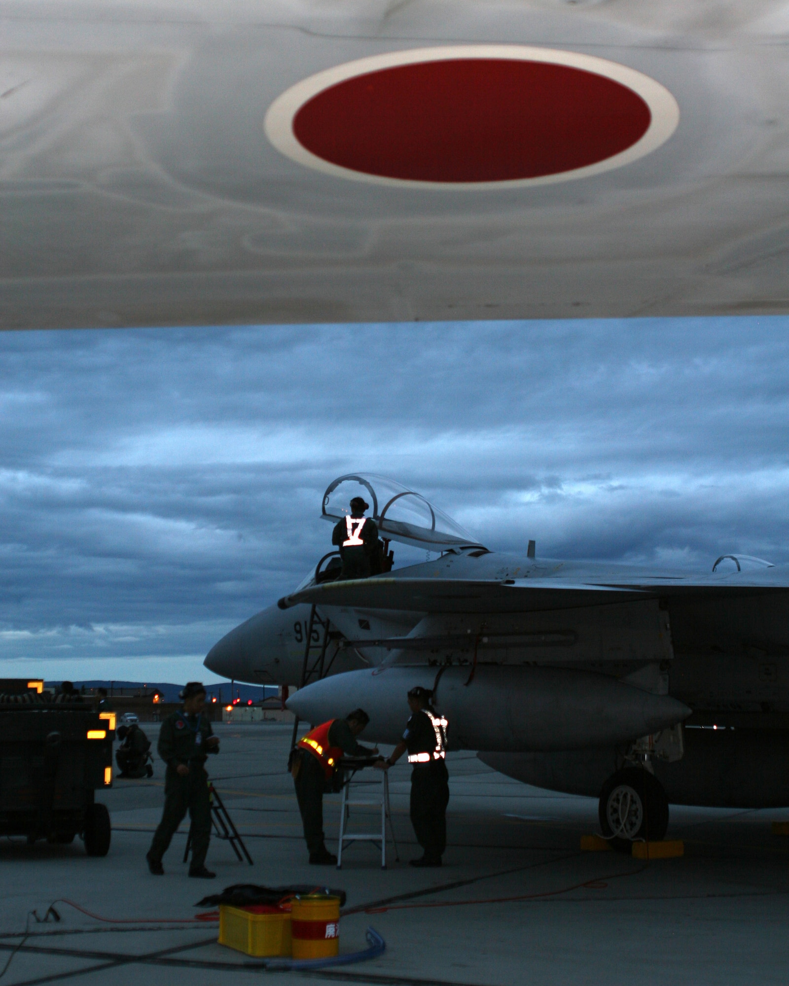 EIELSON AIR FORCE BASE, Alaska --Crew from the 7th Air Wing from Japan Air Self-Defense Force complete post flight procedures after their arrival here with six F-15J aircraft shortly after midnight July 11, 2007. The crews will participate in Red Flag-Alaska exercise July 12-27. The exercise is focused on improving the combat readiness of U.S. forces and providing training for units preparing for air expeditionary force taskings. International partners will include Japan, Mongolia, Spain, Thailand, Turkey and NATO. (U.S. Air Force photo by Capt. Tana R.H. Stevenson)