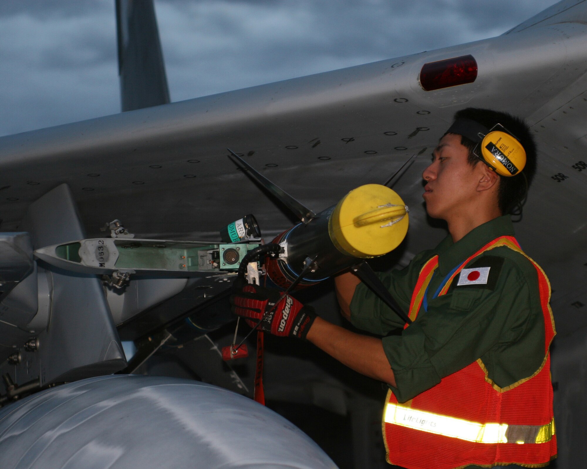 EIELSON AIR FORCE BASE, Alaska -- Staff Sgt. Ryuta Nakhi secures the munitions of an F-15J during post flight procedures here shortly after midnight July 11. The 7th Air Wing of the Japan Air Self-Defense Force arrived with six F-15J aircraft to participate in Red Flag-Alaska exercise July 12-27. The exercise is focused on improving the combat readiness of U.S. forces and providing training for units preparing for air expeditionary force taskings. International partners will include Japan, Mongolia, Spain, Thailand, Turkey and NATO.   (U.S. Air Force photo by Capt. Tana R.H. Stevenson)