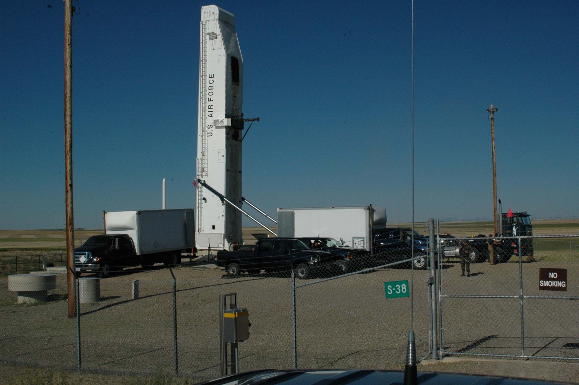 Missile maintenance vehicles are in position at a launch facility near Brady, Mont., July 12 as maintainers remove the Minuteman III missile, marking the start of Defense Department-directed deactivation activities in the 564th Missile Squadron at Malmstrom Air Force Base, Mont.  (U.S. Air Force photo/Valerie Mullett)