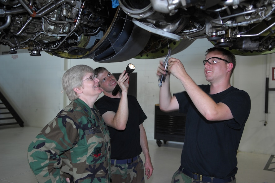MINOT AIR FORCE BASE, N.D. -- Colonel Cynthia Lundell, 5th Maintenance Group commander, looks on as Staff Sgt. Brain Watkins (right) and Airman 1st Class Andrew Kessler, both from the 5th Aircraft Maintenance Squadron, work on an engine of a B-52H Stratofortress July 13. Colonel Lundell took command of the 5th MXG in June. (U.S. Air Force photo by Airman 1st Class Joe Rivera)