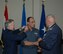 From left, Brig. Gen. Joseph Reheiser, Air Force Security Assistance Center commander, affixes new insignia to Brig. Gen. Mohamed Abbas, Egyptian Air Force liaison officer, while Lt. Col. Juergen Ostendorf, German Air Force liaison officer, offers his congratulations during the promotion ceremony. (Air Force photo by Daryl Mayer)
