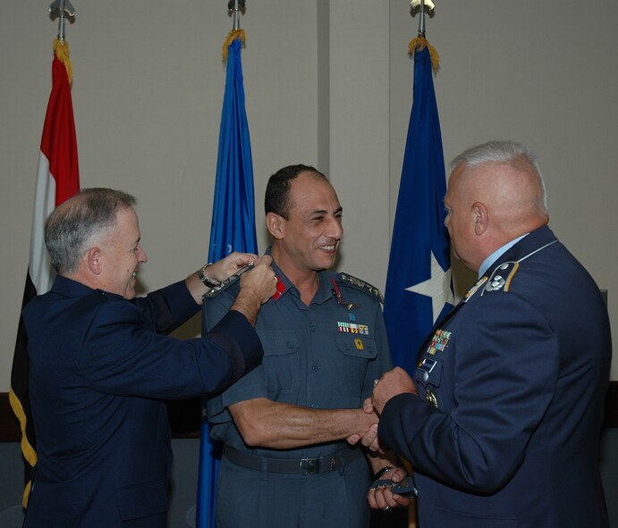 From left, Brig. Gen. Joseph Reheiser, Air Force Security Assistance Center commander, affixes new insignia to Brig. Gen. Mohamed Abbas, Egyptian Air Force liaison officer, while Lt. Col. Juergen Ostendorf, German Air Force liaison officer, offers his congratulations during the promotion ceremony. (Air Force photo by Daryl Mayer)
