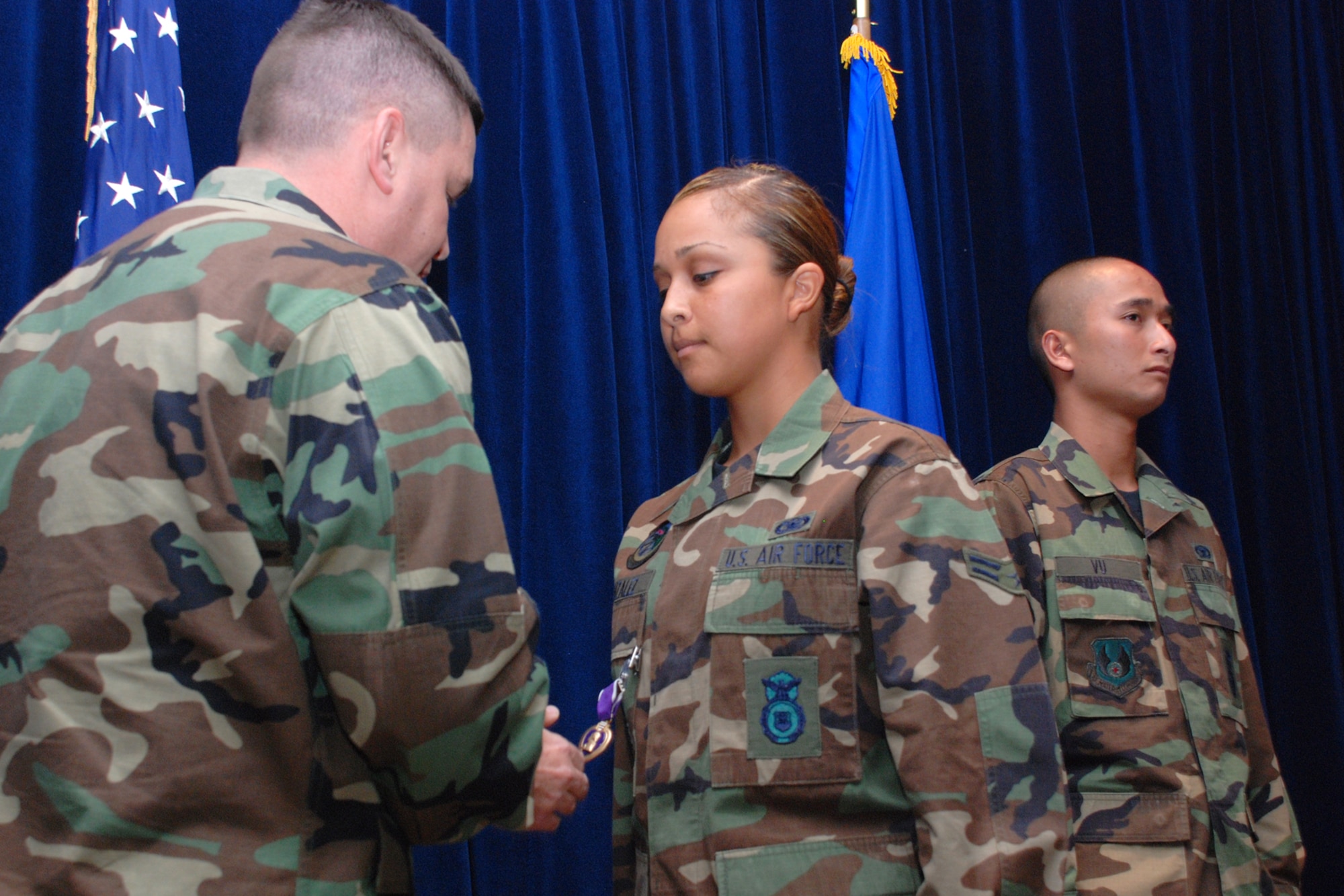 EGLIN AIR FORCE BASE, Fla. -- Airman 1st Class Janette Gonzalez, 96th Security Forces Squadron, receives a Purple Heart from Lt. Col. Timothy Meserve, squadron commander, for her injuries when the vehicle she was driving in Iraq was hit by an explosive device Jan. 20. The Airmen were part of a team due to fill a more traditional billet at a forward-operating base in Mosul, Iraq, but were redirected to Contingency Operating Base Speicher instead, taking on the in-lieu-of mission -- ordinarily tasked to the Army -- of training Iraqi police. The 15-member security forces team was awarded a U.S. Army Commendation Medal. (U.S. Air Force photo by Staff Sgt. Mike Meares)