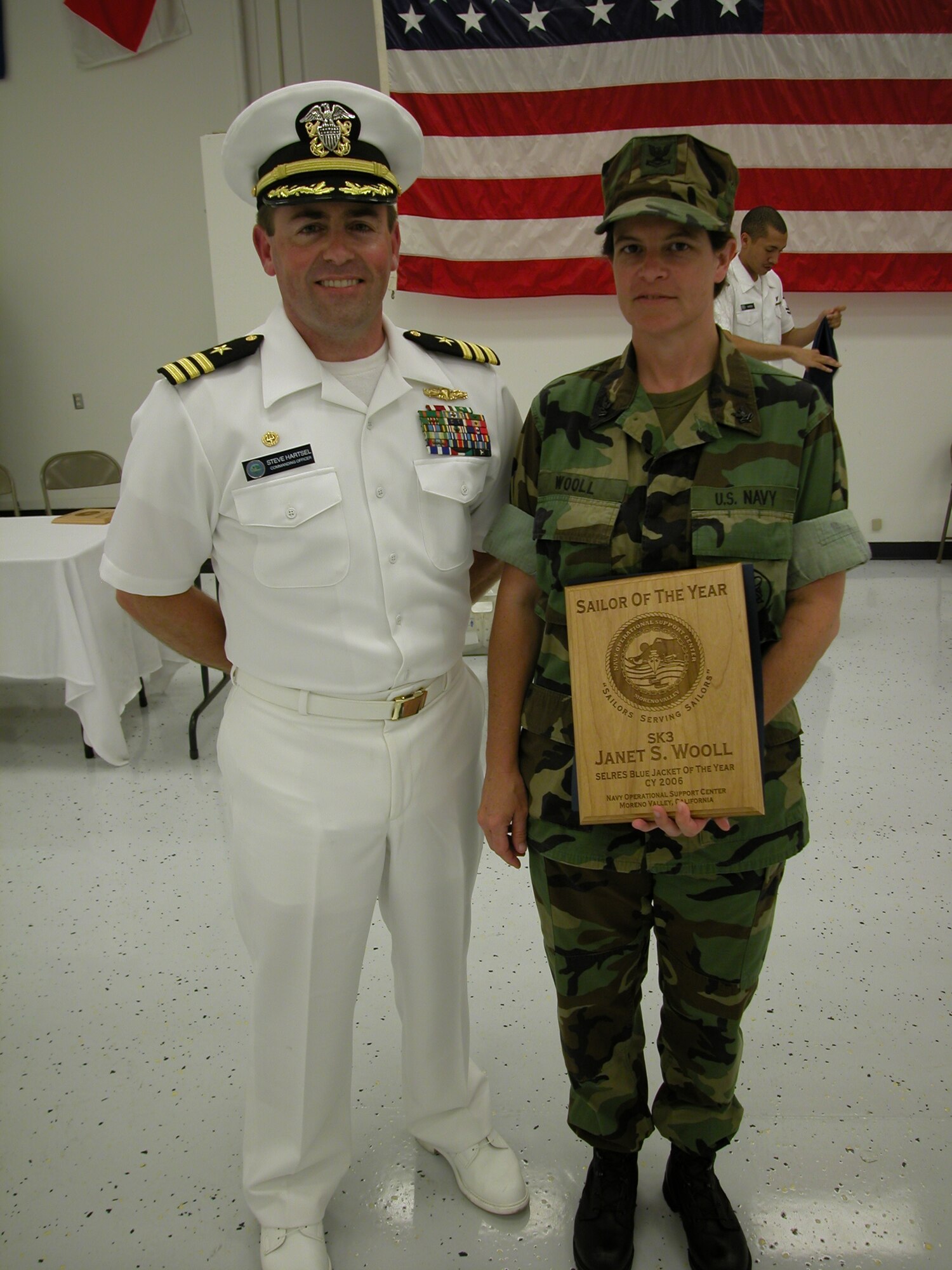 Commander Steve Hartsel (left), Navy Operational Support Center commander, recently presented the Sailor of the Year award for 2006 to Petty Officer Janet Wooll. As assistant physical fitness coordinator, she increased their unit’s overall readiness by 75 percent. She also, as a crew leader, implemented techniques for the staging of 61 containers and thousands of line items, significantly contributing to saved man-hours and production effectiveness as a crew leader. She is currently assigned to the Naval
Facilities Expeditionary Logistics Center, Surge Det. A. (U.S. Air Force photo by Staff Sgt. Joe Davidson)