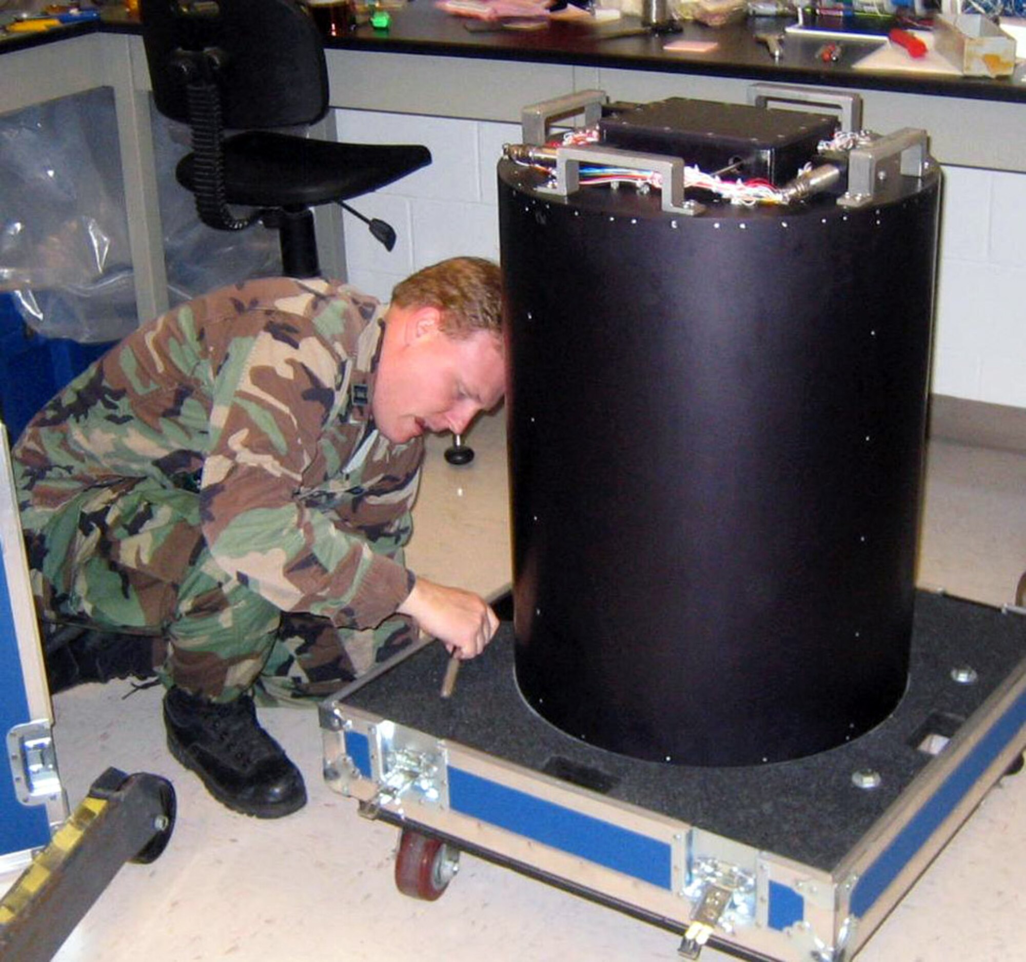 Capt. Jeremy Owens packages an Air Force Institute of Technology experiment for transport to the Johnson Space Center for preflight testing June 5 at the AFIT laboratory at Wright-Patterson Air Force Base, Ohio. An upcoming space shuttle mission is going to feature a flight hardware experiment designed by AFIT students from the graduate school of engineering and management's department of aeronautics and astronautics. (U.S. Air Force photo/Dr. Richard Cobb)
