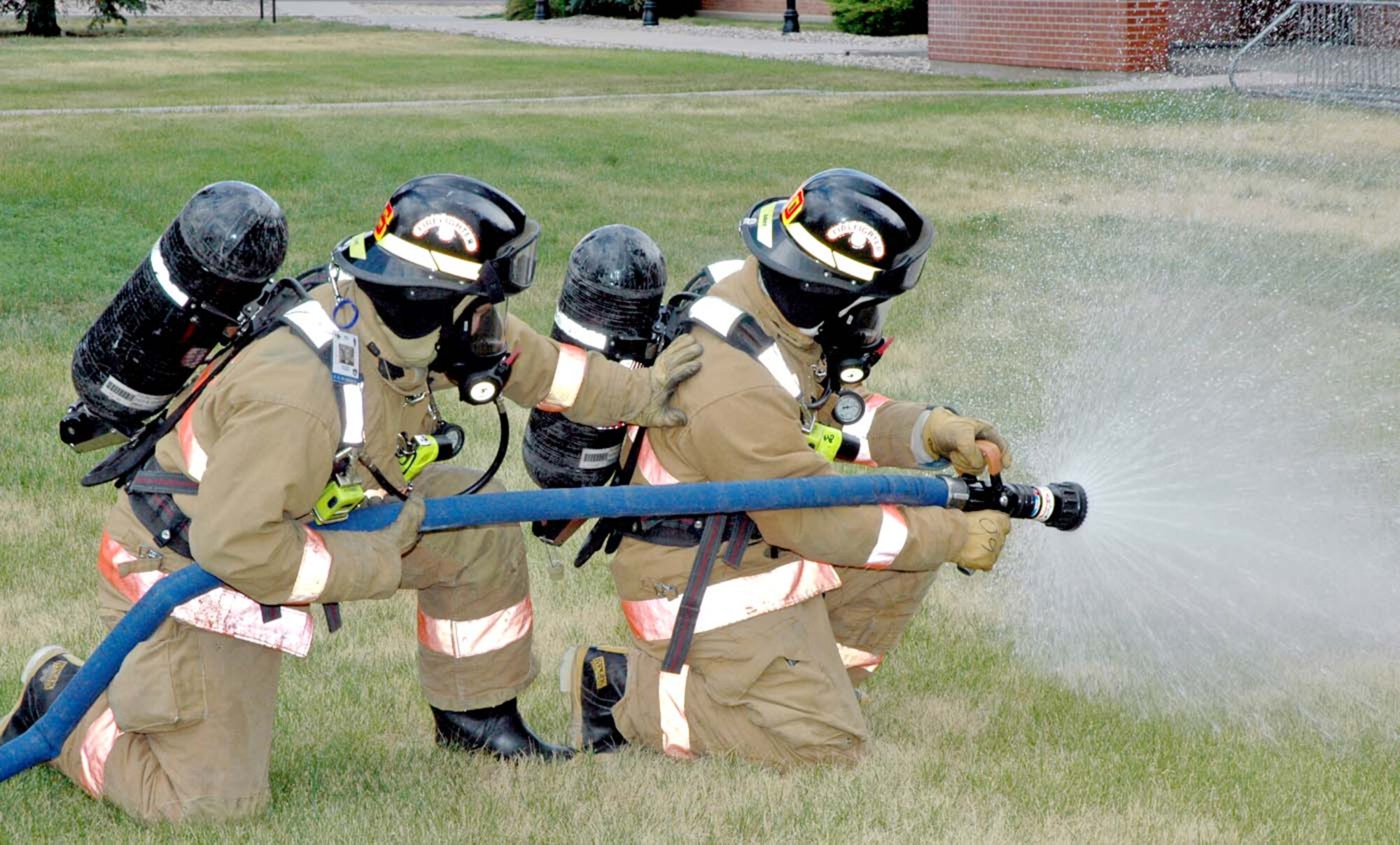 Warren firefighters Senior Airman Alan Drake and Airman 1st Class Andrew Kose hone their skills by practicing what they would do during a real fire event. The Air Force named the Warren Fire Department the best of its size in 2006 (Photo by Airman 1st Class Daryl Knee).