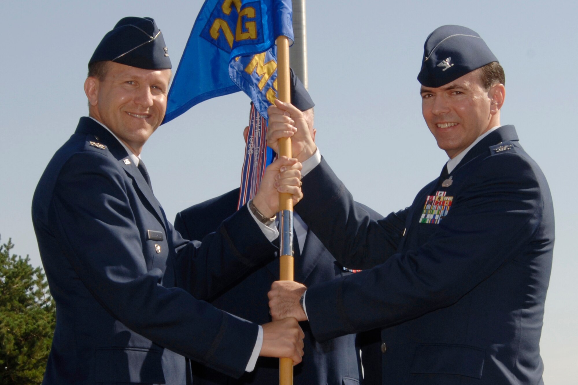 MCCONNELL AIR FORCE BASE, Kan. -- Col. John Zazworsky, left, 22nd Air Refueling Wing vice commander, hands the 22nd Mission Support Group guidon and command of the group to Col. Mark White July 6 during a change of command ceremony here. (Photo by Senior Airman Jamie Train)