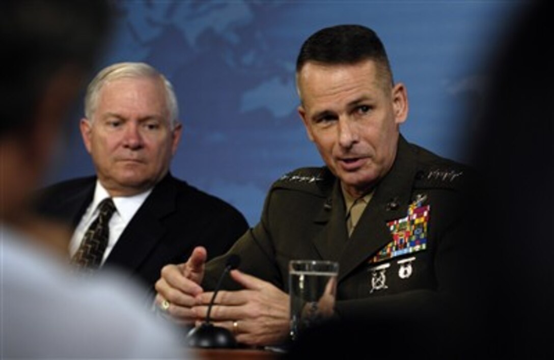 Chairman of the Joint Chiefs of Staff Gen. Peter Pace (right), U.S. Marine Corps, responds to a question during a press conference with Secretary of Defense Robert M. Gates in the Pentagon on July 13, 2007.  Pace and Gates discussed the Iraq Initial Benchmark Assessment Report and current operations in Iraq with reporters.  