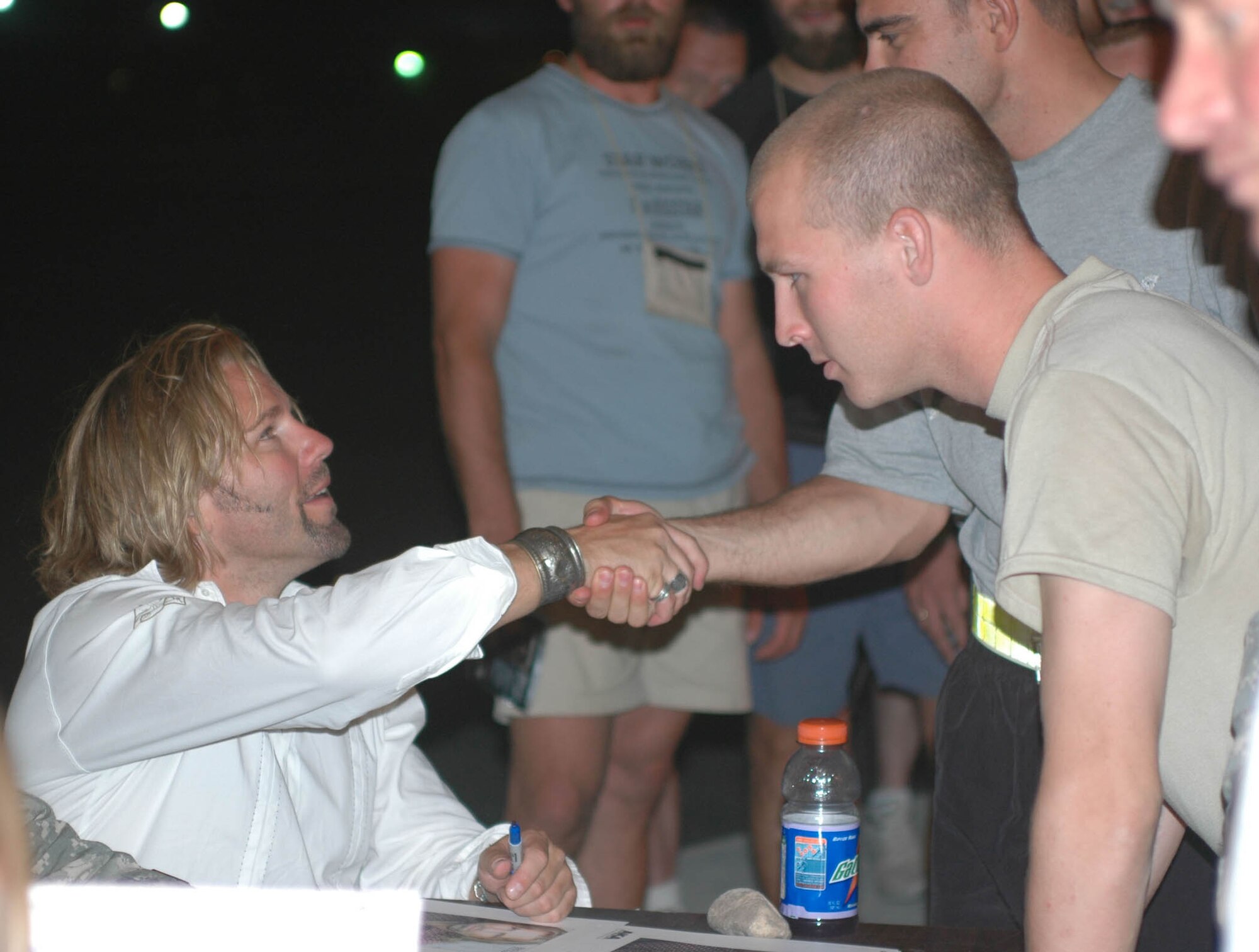 Country music artist Brian Stace shakes hands and talks to U.S. Servicemembers after a concert at Kandahar Air Field July 7. Stace says he has learned a lot about the military and the war from talking to the Soldiers on the ground. (U.S. Army photo by Sgt. Tony J. Spain)