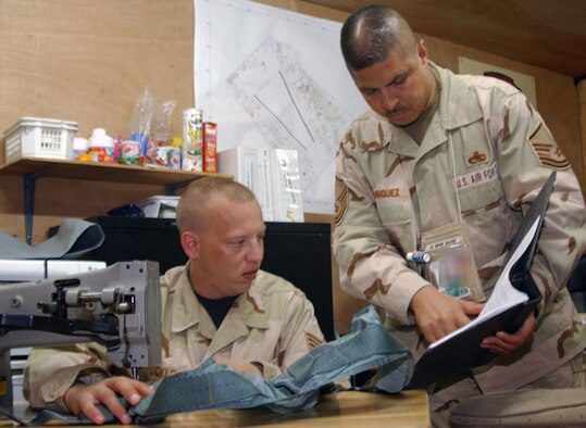 Master Sgt. Jose A. Rodriguez shows Staff Sgt. Reid Huckle a procedure on a technical order, a book containing instructions on how to fix things, at Balad Air Base, Iraq. Sergeants Rodriguez and Huckle are survival equipment technicians assigned to the 322nd Expeditionary Maintenance Squadron. Sergeant Rodriguez is deployed from Naval Air Station Joint Reserve Base, Fort Worth, Texas, and Sergeant Huckle is deployed from Misawa Air Base, Japan. (U.S. Air Force photo illustration/Senior Airman Olufemi A. Owolabi) 