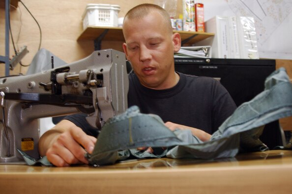 Tech. Sgt. Huckle Reid, a survival equipment shop technician, modifies a harness at Balad Air Base, Iraq. Sergeant Huckle is assigned to the 322nd Expeditionary Maintenance Squadron and deployed from Misawa Air Base, Japan. (U.S. Air Force photo/Senior Airman Olufemi A. Owolabi) 