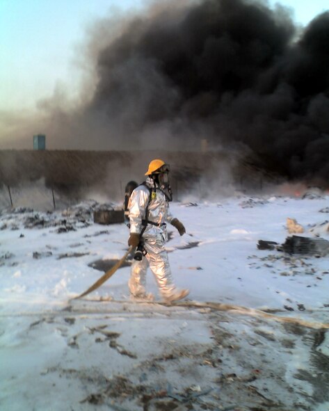 A March Air Reserve Base firefighter assesses the scene after the team applied the foam. (U.S. Air Force photo by Chris Christianson)