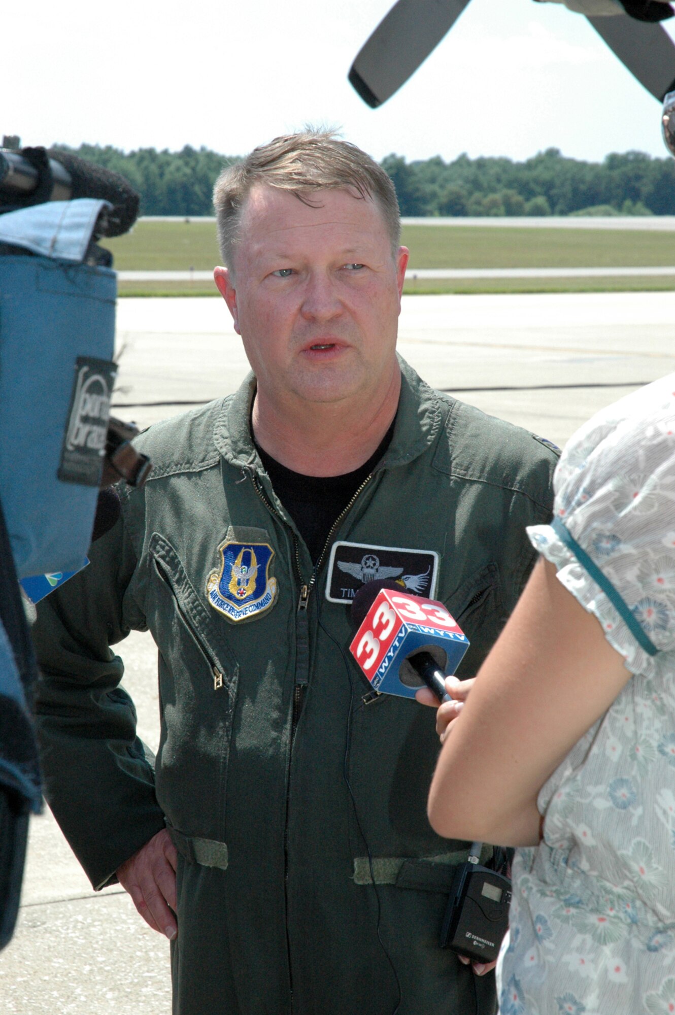 YOUNGSTOWN AIR RESERVE STATION, Ohio -- Col. Timothy J. Thomson, commander of the 910th Airlift Wing, speaks to local news media representatives July 14 after landing from his final C-130 flight.  Col. Thomson retires July 15 after 34 years of service with the Air Force and Air Force Reserve.  He assumed command of the 910th Airlift Wing June 20, 2004 and will relinquish his command of the 910th to Col. Karl McGregor during a change of command ceremony July 15.  Col. McGregor was previously commander of the 439th Operations Group at Westover Air Reserve Base, Mass. (U.S. Air Force photo/Senior Airman Ann Wilkins-Jefferson)