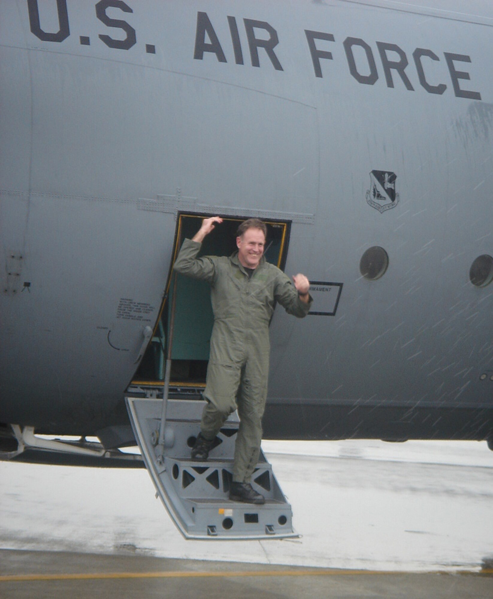 Col. Scott Goodwin, 374th Airlift Wing commander, steps off a C-130H during his fini-flight Thursday. (Photo by Masao Abe)