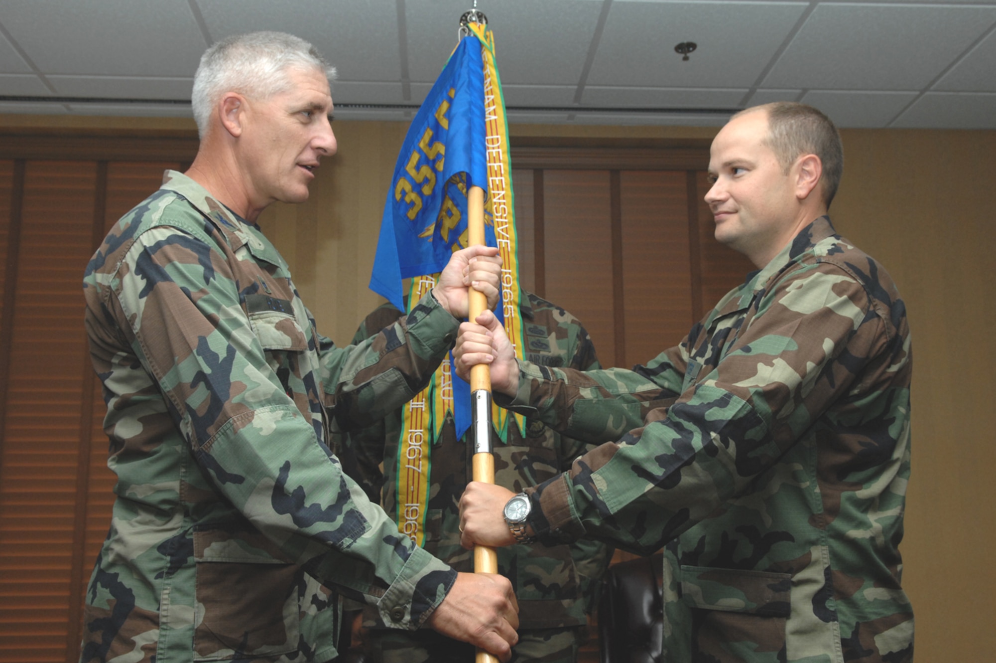 Maj. David A. Paynter (right) receives the 355th Logistics Readiness Squadron guidon from 355th Mission Support Group Commander Col. Hal V. Hoxie during a change-of-command ceremony at the Mirage Officer's Club here July 12. Major Paynter was previously the chief of deployment policy and guidance for Headquarters Air Combat Command at Langley Air Force Base, Va. (U.S. Air  Force photo/Airman First Class Noah R. Johnson)