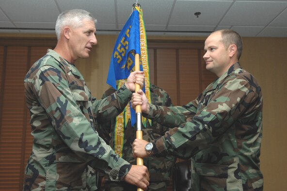 Maj. David A. Paynter (right) receives the 355th Logistics Readiness Squadron guidon from 355th Mission Support Group Commander Col. Hal V. Hoxie during a change-of-command ceremony at the Mirage Officer's Club here July 12. Major Paynter was previously the chief of deployment policy and guidance for Headquarters Air Combat Command at Langley Air Force Base, Va. (U.S. Air  Force photo/Airman First Class Noah R. Johnson)