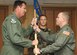 Lt. Col. Denis P. Doty (right) receives the 563rd Operations Support Squadron guidon from 563rd Rescue Group Commander Col. Lee K. DePalo during a change-of-command ceremony at the Mirage Officer's Club here July 13. Colonel Doty, who has accumulated more than 3,800 flying hours, assumed command after serving as chief of safety for the 23rd Wing at Moody Air Force Base, Ga. (U.S. Air Force photo/Airman 1st Class Noah R. Johnson)