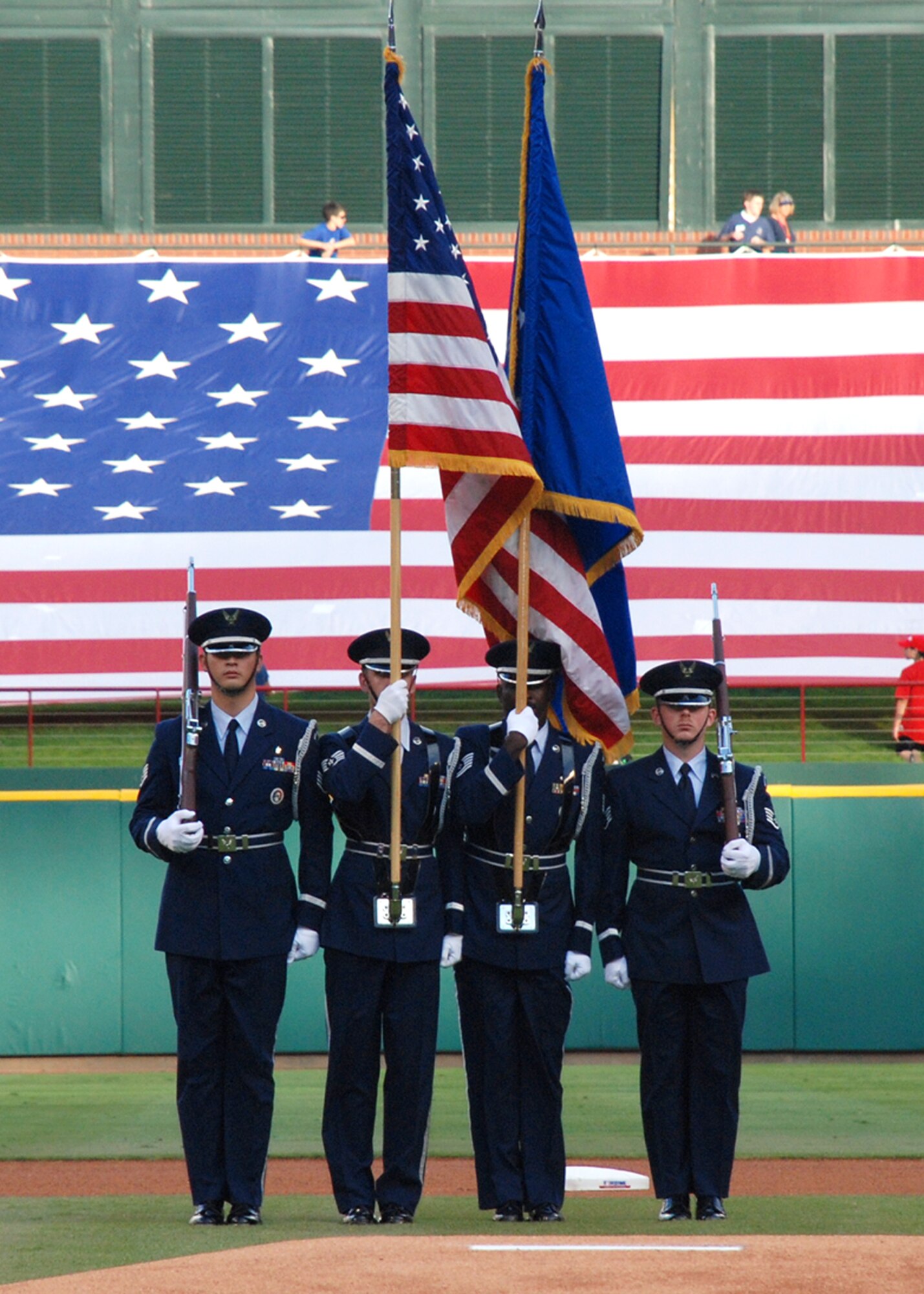 Air Force Honor Guard prepare to post "the colors" at a July 4th enlistment event for 120 Delayed Enlistment Program recruits at a Texas Rangers game, at Ameriquest Stadium near Dallas, Texas. (U.S. Air Force Photo/Master Sgt. Wade Trahan)