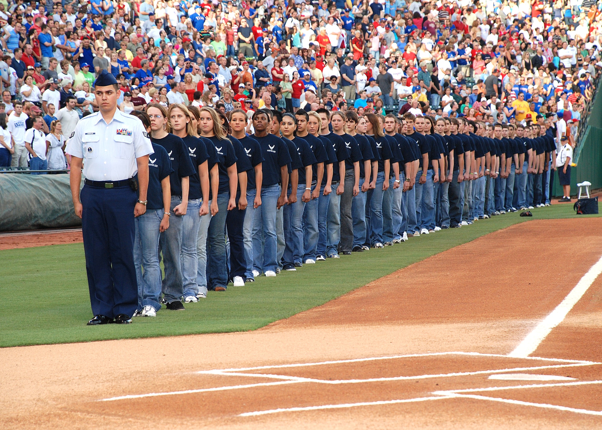 Running along the left-field base line, half of 120 Delayed Enlistment Program recruits get ready to take the Oath of Enlistment into the Air Force at a July 4th Texas Rangers game, at Ameriquest Stadium near Dallas, Texas. (U.S. Air Force Photo/Master Sgt. Wade Trahan)
