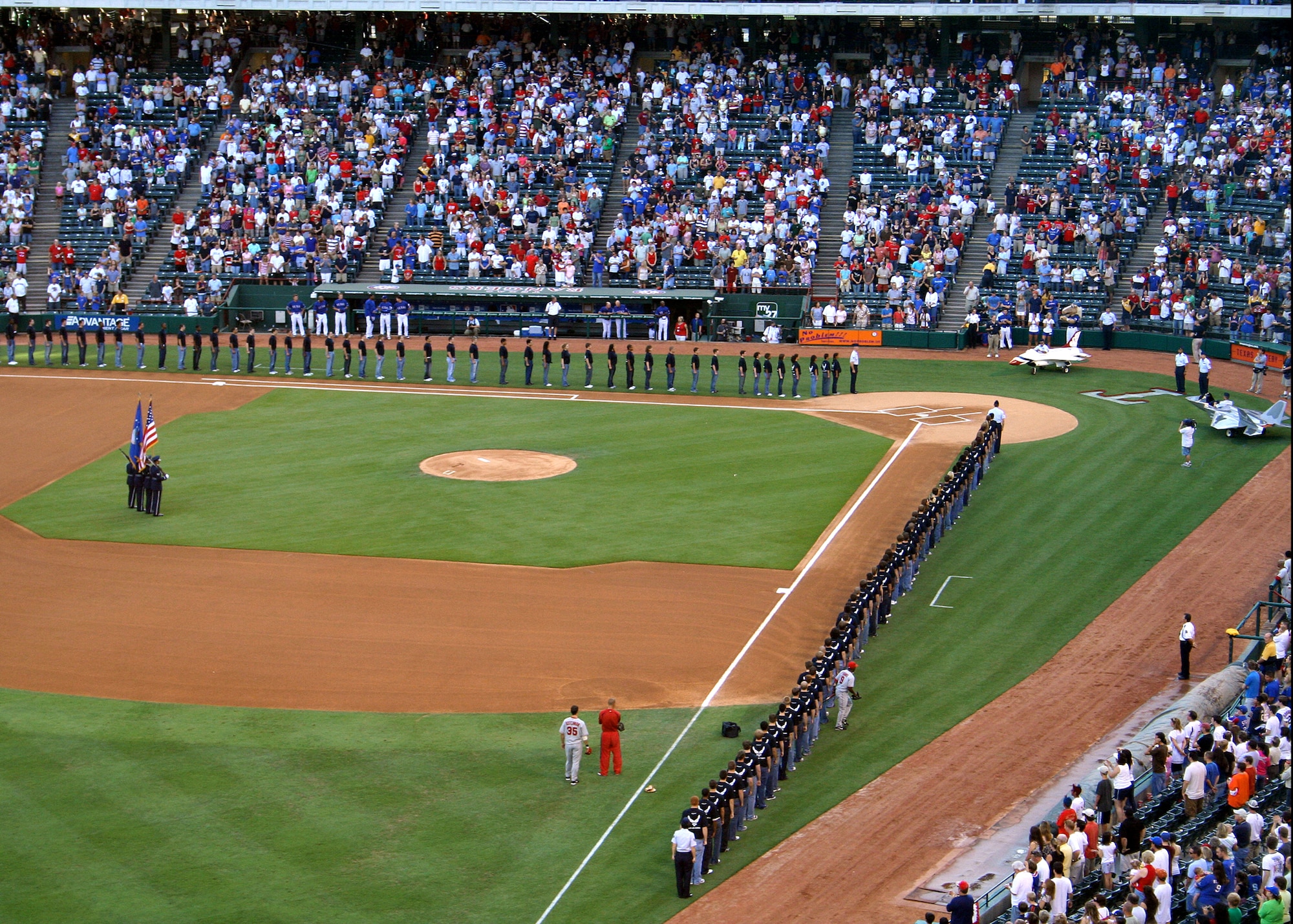 One hundred twenty Delayed Enlistment Program recruits get ready to take the Oath of Enlistment into the Air Force at a July 4th Texas Rangers game, at Ameriquest Stadium near Dallas, Texas. (U.S. Air Force Photo/Master Sgt. Glenn Perkins)