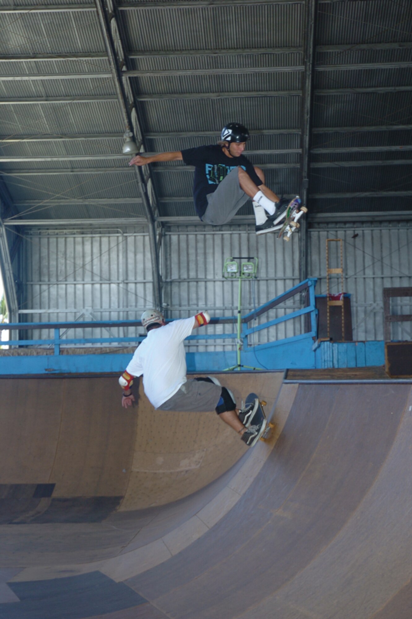 Chris Kays gets a front-side air over his dad Mike in one of two ‘bowls’ at Hickam’s Sk8 Park. Anthony Eischens, 8, jumps from one ramp to another. Photo by Mark Munsey