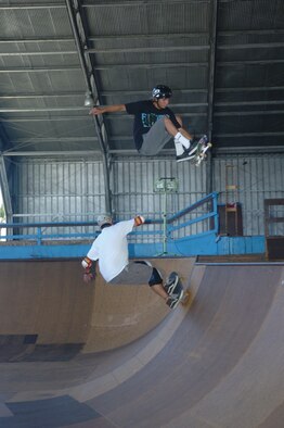 Chris Kays gets a front-side air over his dad Mike in one of two ‘bowls’ at Hickam’s Sk8 Park. Anthony Eischens, 8, jumps from one ramp to another. Photo by Mark Munsey