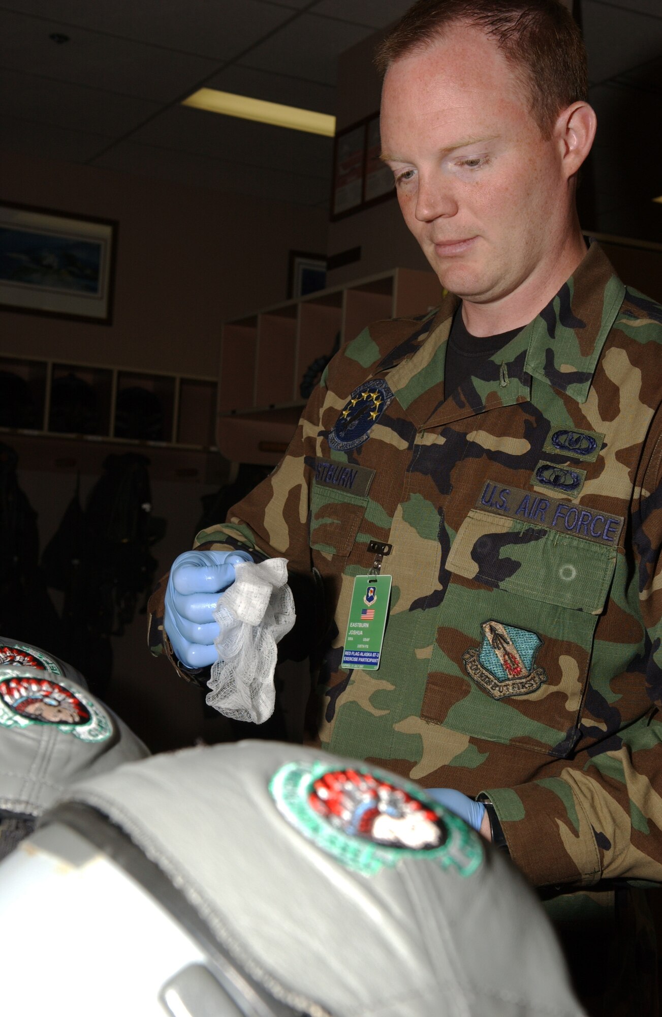 EIELSON AIR FORCE BASE, Alaska -- Senior Airman Josh Eastburn, 335th Fighter Squadron Life Support, Seymour Johnson AFB, N.C., conducts a post flight sanitization of the pilot helmets on July 13. Red Flag-Alaska enables aviation units to sharpen their combat skills by flying ten simulated combat sorties in a realistic threat environment. Additionally, the training allows them to exchange tactics, techniques, and procedures and improve interoperability. (U.S. Air Force Photo by Airman 1st Class Jonathan Snyder)