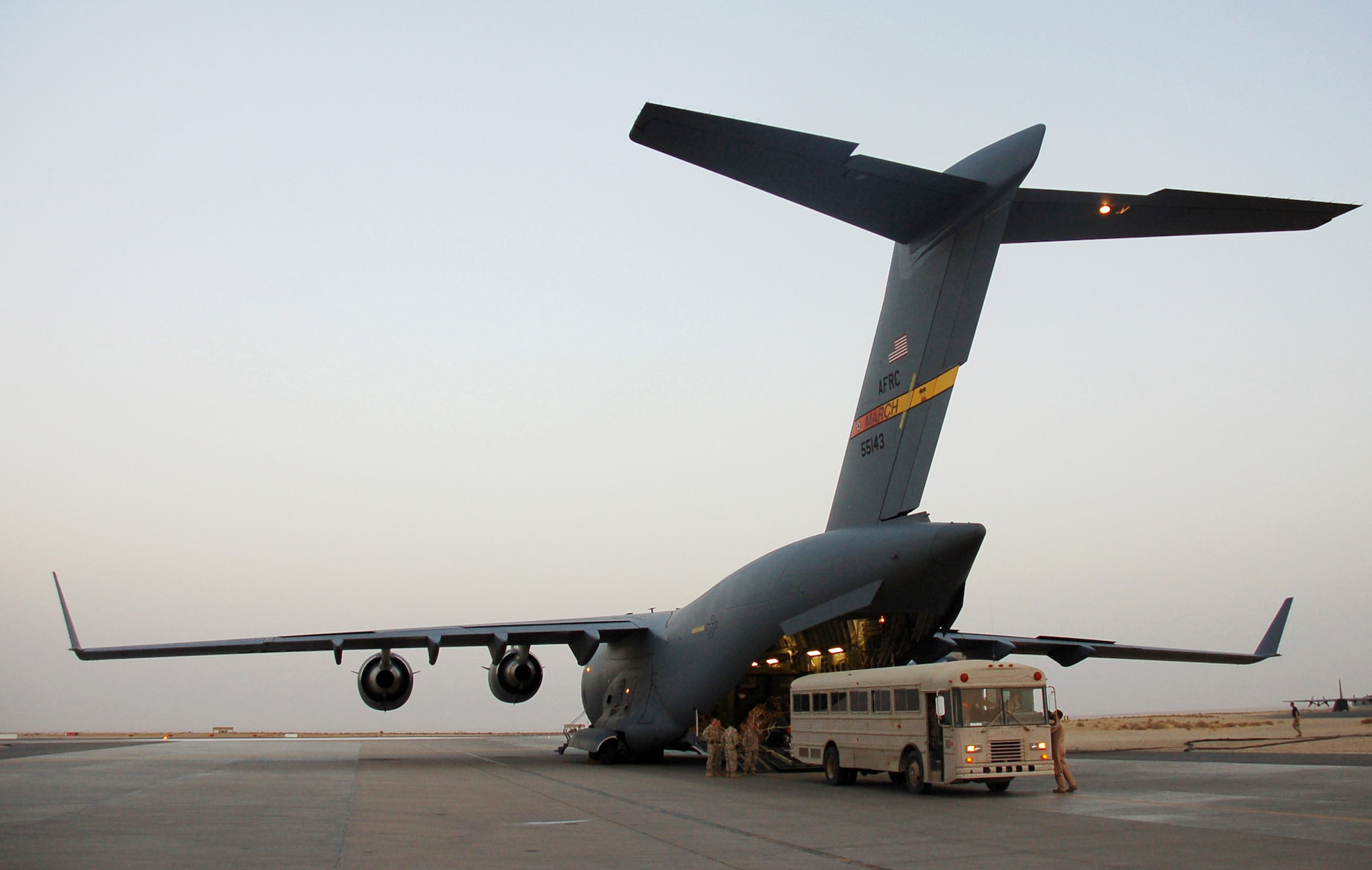 A med-evac bus backs up to the loading ramp on a C-17 Globemaster III July 1 so Airmen from the 386th Air Expeditionary Wing's Contingency Aeromedical Staging Facility at this Southwest Asia base can transport the patients from the aircraft to the CASF where they will receive care until they can be flown to medical centers in Europe and the continental U.S. for definitive care.    (U.S. Air Force photo/Staff Sgt. Raymond Mills)