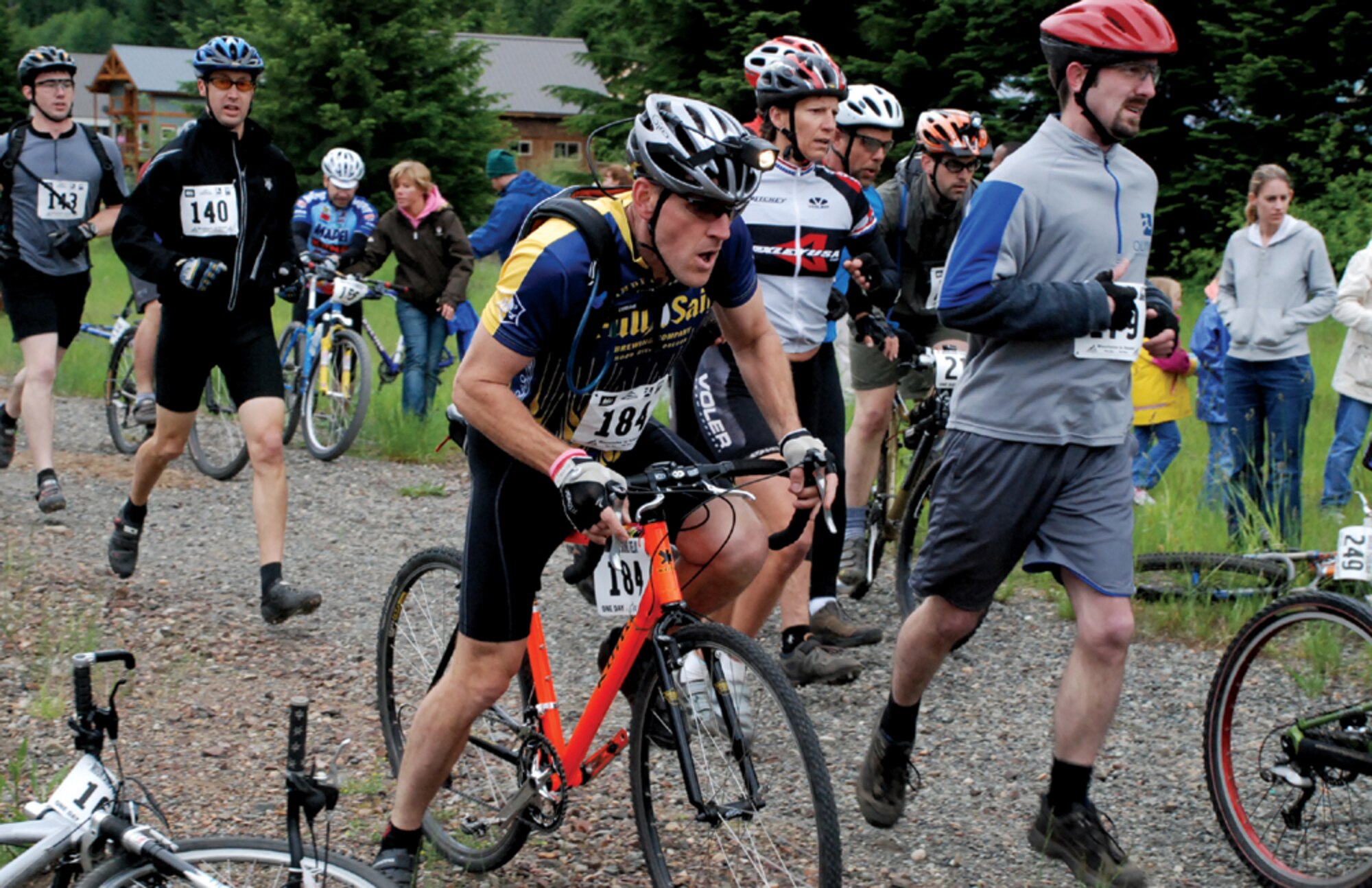 Maj. Timothy Greminger, on bike, competes in the Mountain to Sound relay race near Seattle. A reservist with the 446th Airlift Wing, Major Greminger, from the 728th Airlift Squadron, and 14 other people from McChord, participated in the 100-mile adventure relay from Snoqualmie Pass to Puget Sound, June 24.  (Courtesy photo/Maj. Timothy Greminger)