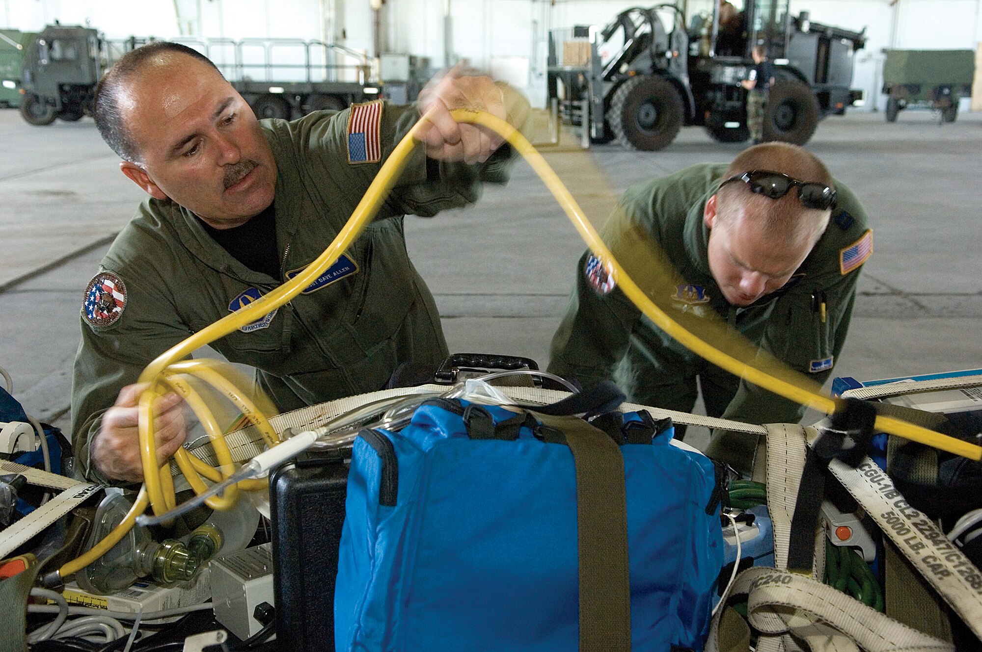 Air Force Reserve Airmen, Tech. Sgt. Dave Allen, left, and Capt. Joe Foss, both from  the 446th Aeromedical Evacuation Squadron, McChord Air Force Base, Wash., prepare medical equipment to load on a KC-135 as they practice their skills for Air Mobility Command's Rodeo 2007. More than 55 U.S. and international teams are slated to participate in AMC's Rodeo 2007 to be held July 22 through 28 at McChord. The competition focuses on readiness, and features airdrop, air refueling, and other events showcasing security forces, aerial port, maintenance and aeromedical evacuation personnel. (U.S. Air Force photo/Abner Guzman)