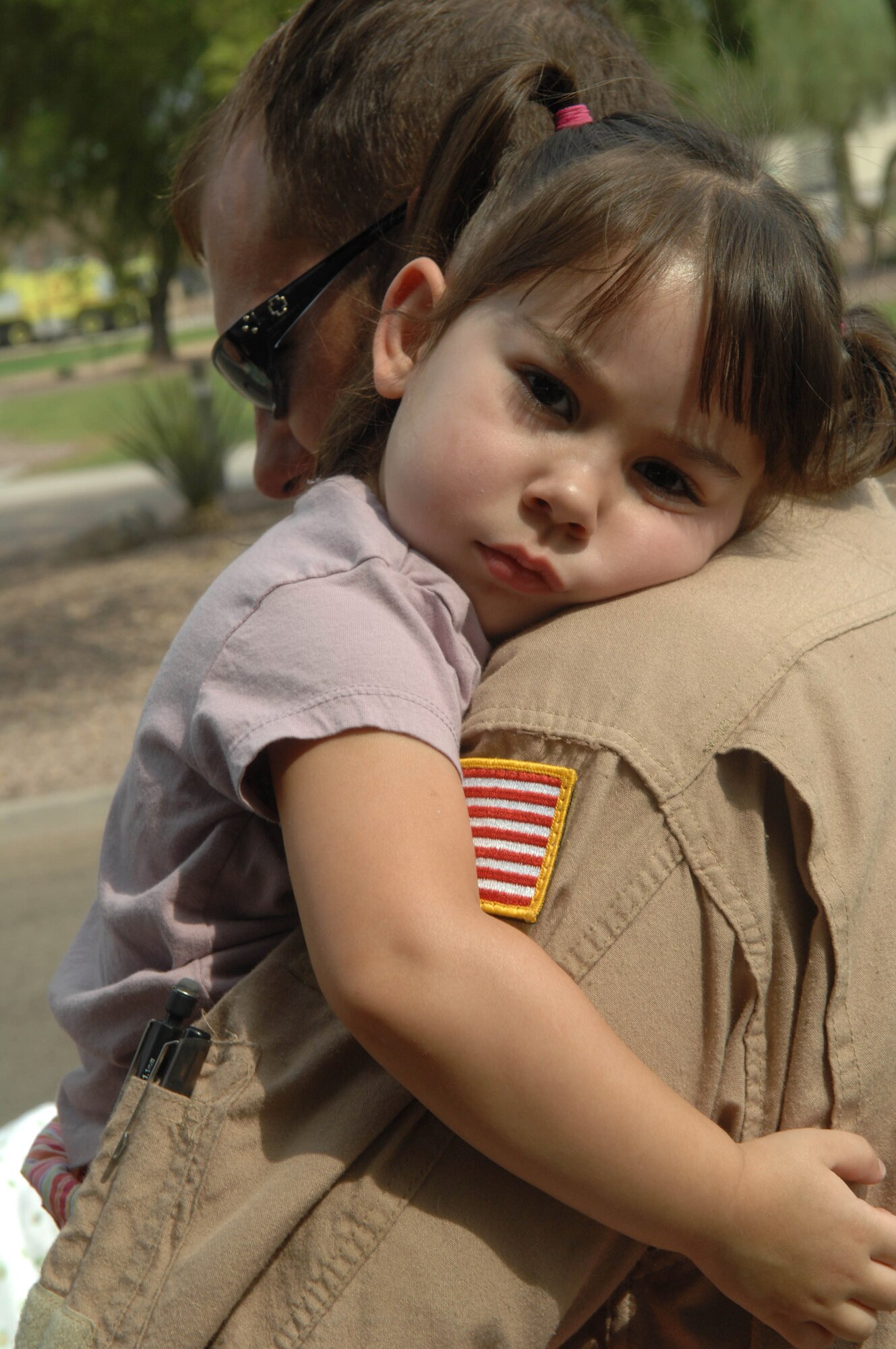 Two-year-old Madison rests on the shoulder of her dad, Staff Sgt. Todd McKerracher, after being reunited July 9 at Davis-Monthan Air Force Base, Ariz., after returning from a deployment to Balad Air Base, Iraq. Madison is the daughter of Staff Sgt. Darlene McKerracher of the 355th Communications Squadron and Sergeant Todd McKerracher of the 55th Rescue Squadron. (U.S. Air Force photo/Senior Airman Christina D. Ponte)