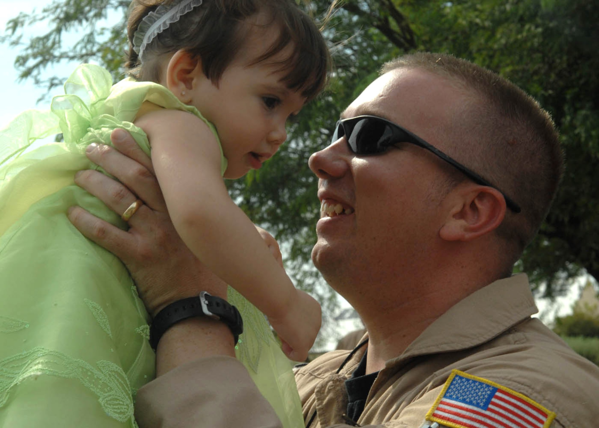 Staff Sgt. Garry Gray hugs his 1-year-old daughter Jessica Denise as they are reunited July 9 after his return from a 120-day deployment to Balad Air Base, Iraq, at Davis-Monthan Air Force Base, Ariz. Sergeant Gray is an aerial gunner assigned to the 55th Rescue Squadron. (U.S. Air Force photo/Senior Airman Christina D. Ponte)