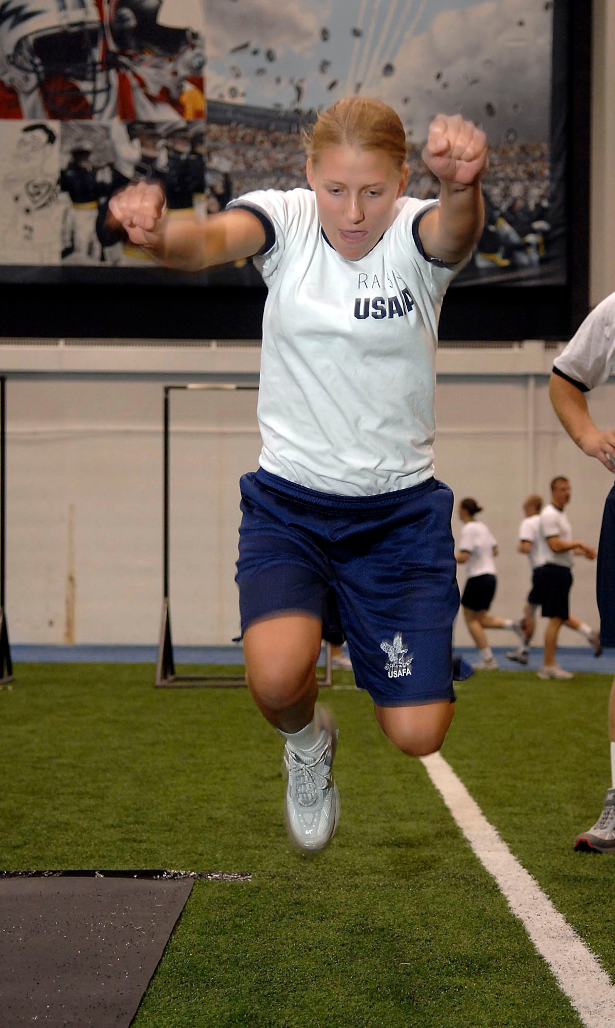 Cadet 4th Class Sarah Ruckriegle performs a standing long-jump during her physical fitness test  July 12 at the U.S. Air Force Academy, Colo. Cadet Ruckriegle got the maximum score by completing over a 7'2" jump. The Academy received 9,162 application for this year's class in which only 1,600 were offered appointments. These first-year cadets receive basic discipline and skills to help develop them into officers. (U.S. Air Force photo/Tech. Sgt. Larry A. Simmons)