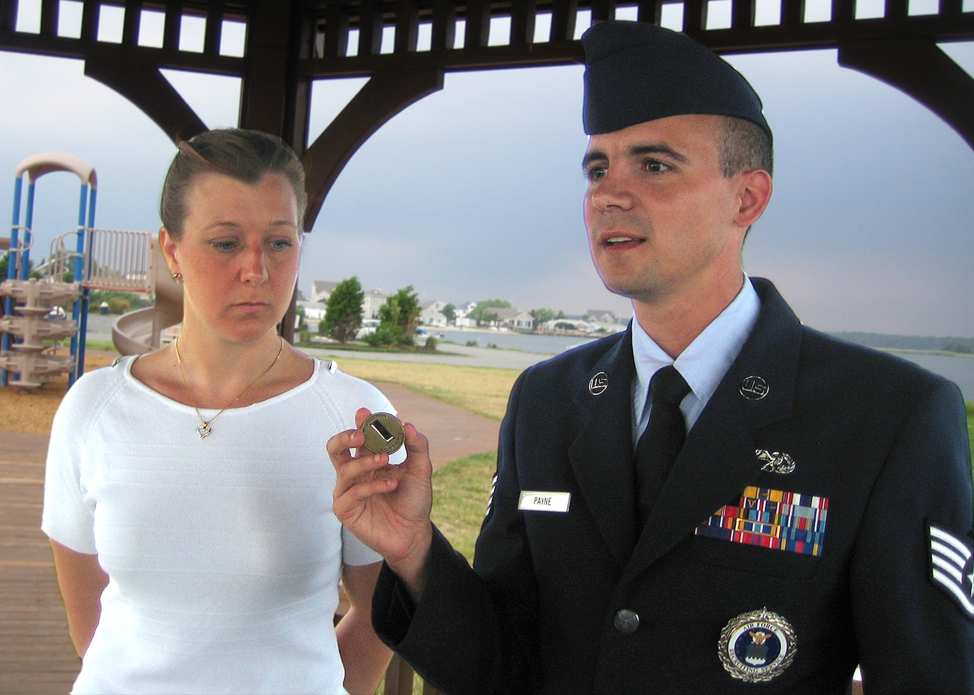 Air Force recruiter Staff Sgt. Robert Payne prepares to coin newly minted 1st Lt. Susan M. Senko, an officer accessions nurse candidate, recently at Forked River, N.J. The Air Force Sergeants Association named the Bala Cynwyd, Pa., recruiter as its 2007 Pitsenbarger Award recipient. The award recognizes Air Force enlisted members who perform heroic acts that result in saving a life or preventing serious injury. (Courtesy photo illustration)